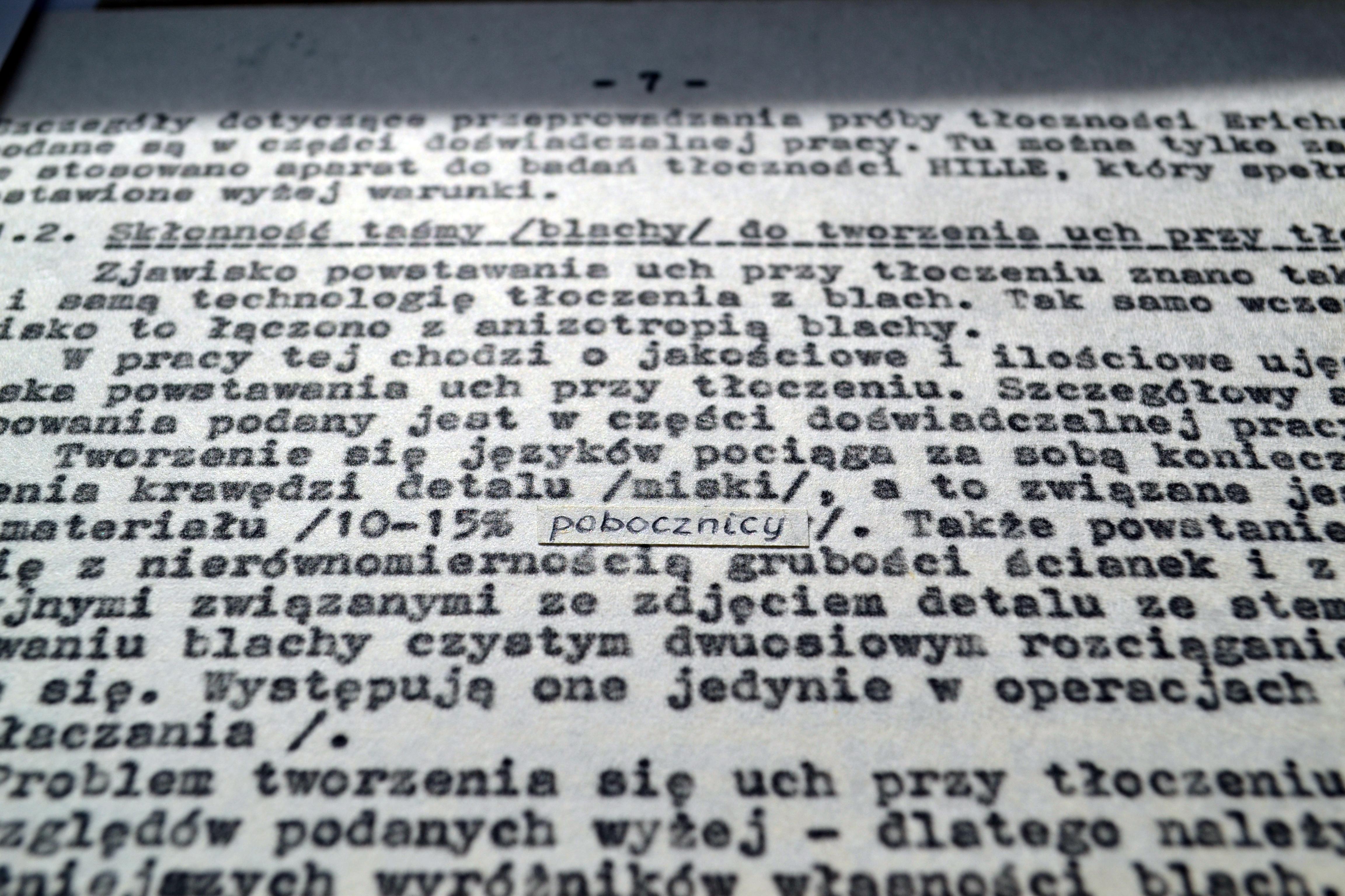 Maszynopis omawiający zjawisko powstawania „uch” (języczków) przy tłoczeniu blach, powiązane z anizotropią materiału. Widoczne ręczne poprawki, m.in. podkreślone słowo „pobocznicy”